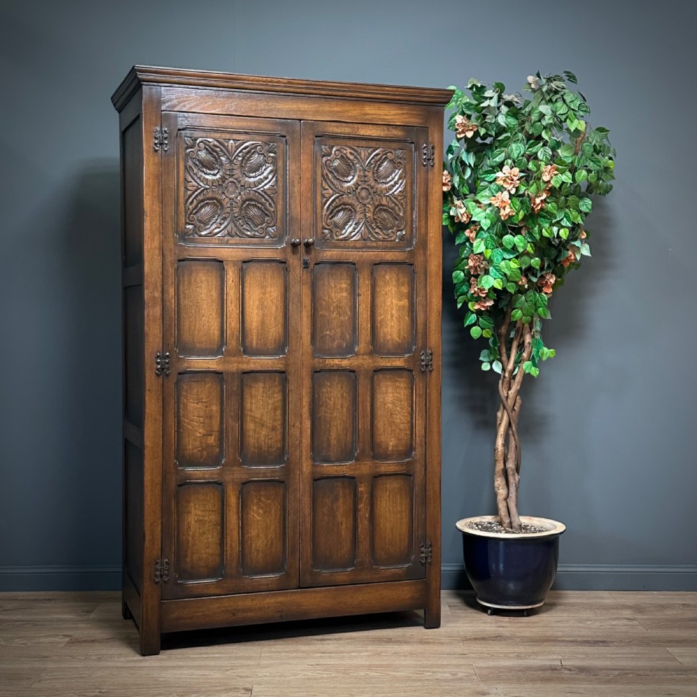 attractive large vintage tudor style panelled carved oak double wardrobe