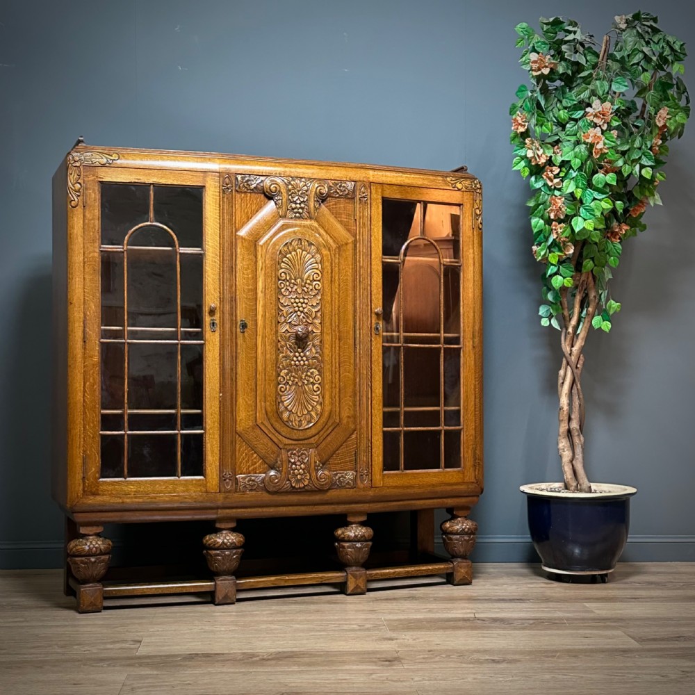 attractive large art deco carved oak glazed triple door bookcase cabinet