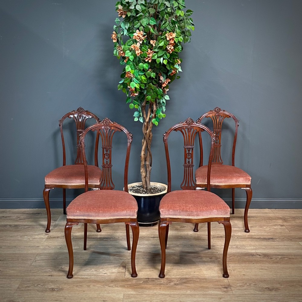 attractive set of four antique carved mahogany upholstered dining chairs