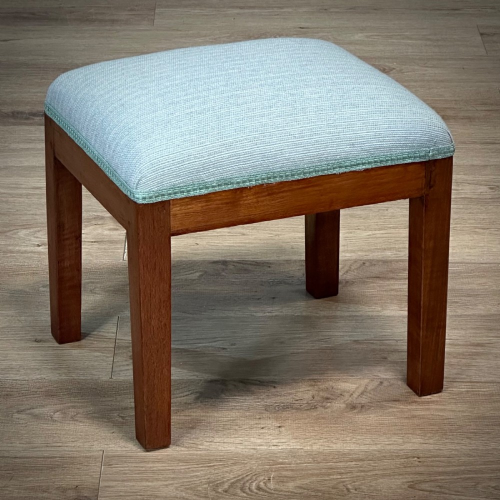attractive vintage teak newly upholstered stool in a light blue fabric