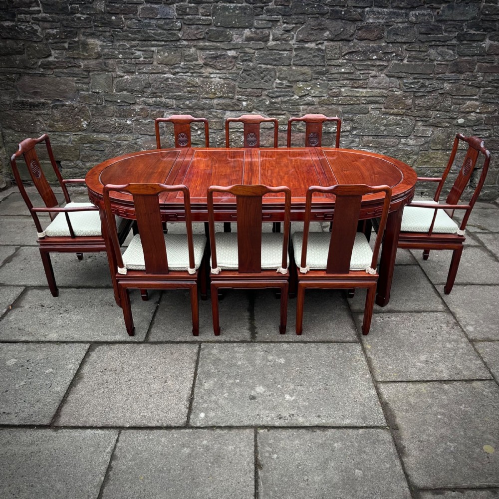 attractive large oriental carved cherrywood extending dining table and eight chairs