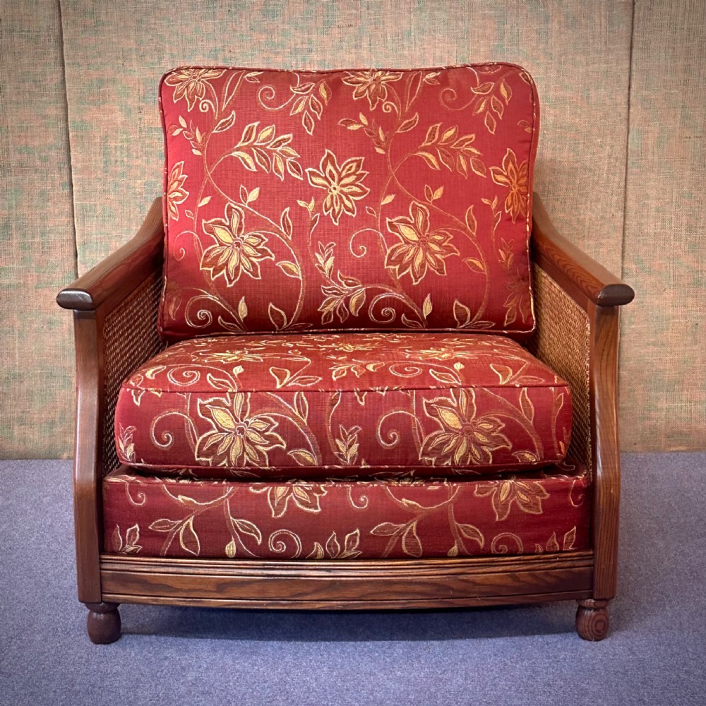 attractive ercol bergere red and gold upholstered armchair